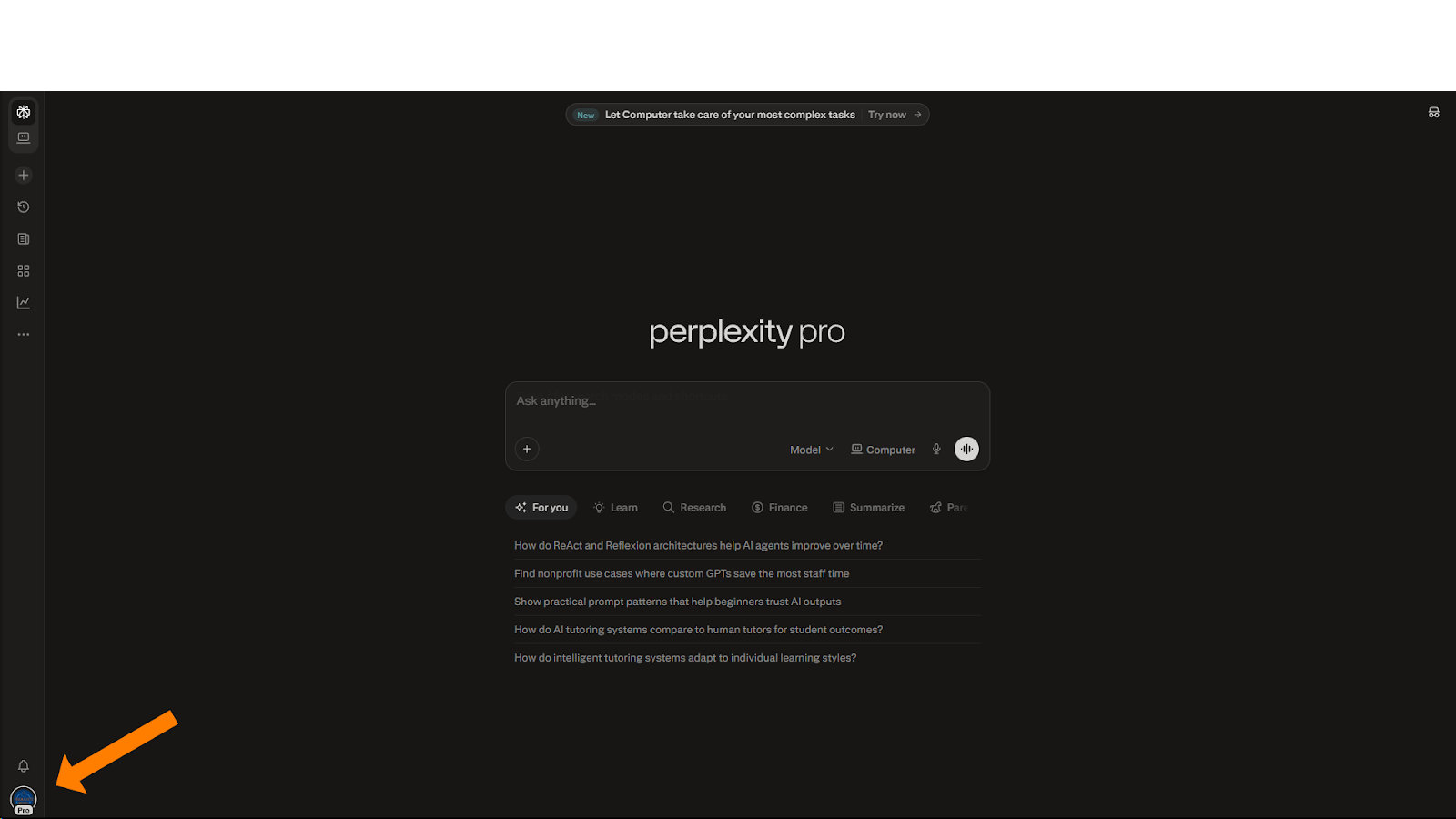 A full-screen screenshot of the Perplexity Pro home page in dark mode. An orange arrow in the bottom-left corner points to the user's profile icon, which is used to access account settings. The central search bar features the "Computer" mode toggle, and several suggested search queries are listed below it.